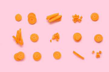 Slices of fresh carrots on pink background