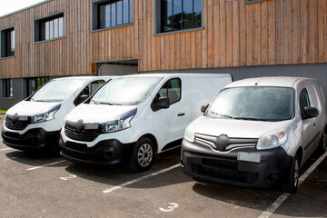Three White Delivery Trucks vans fleet of cargo trucks courier service Warehouse Building
