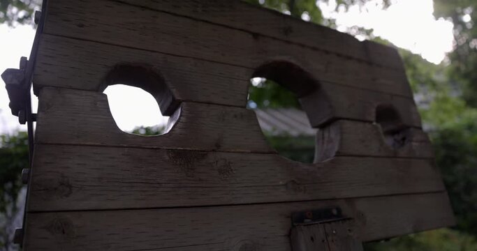 Wooden Pillory near wooded area for restraining criminals - close up