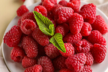 Plate with fresh raspberries and mint, closeup