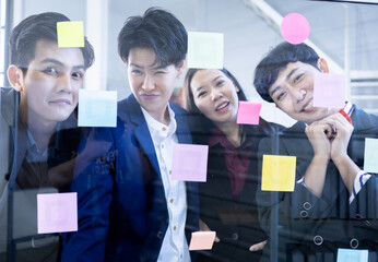 Successful happy workers Group of asian business people with diverse genders (LGBT) and use post it...