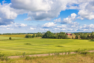 Fototapeta na wymiar Rural landscape view with fields and a barn