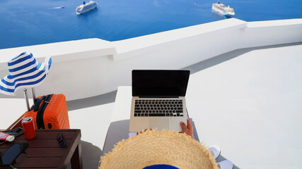 Cozy lifestyle with digital nomad freelancer man lying on the bed Mediterranean Sea ,Oia...