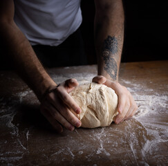 cool pizza baker is preparing the pizza dough.
