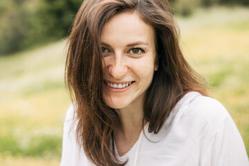 Psychological portrait of a smiling cute girl in nature