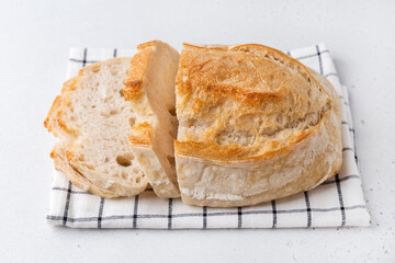 Homemade bread on a light background. Sliced bread on the table.
