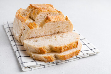 Homemade bread on a light background. Sliced bread on the table.