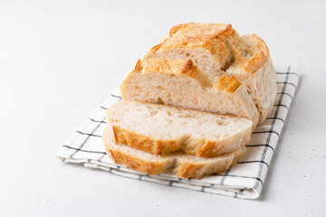 Homemade bread on a light background. Sliced bread on the table.