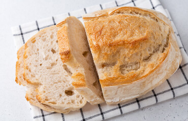 Homemade bread on a light background. Sliced bread on the table.