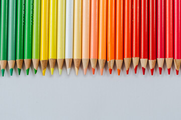 Colored multicolored wooden pencils on a white background