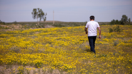 a man walking into grass land