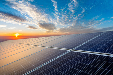 Solar panels and beautiful sunset clouds. green energy concept.