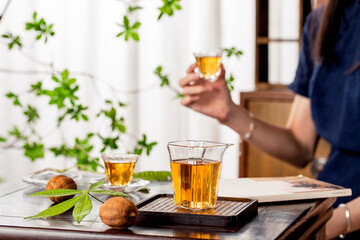 Scene with oriental woman drinking tea, tea in a glass teacup, traditional tea set, oriental style...