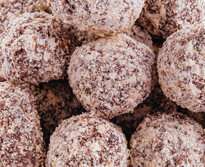 Chocolate truffles triangle close up background