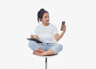 Woman talking on phone while using tablet