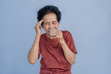 Asian old woman feeling dizzy smelling essential oils To alleviate headaches, migraines, and...