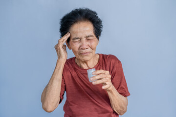 Asian old woman feeling dizzy smelling essential oils To alleviate headaches, migraines, and...