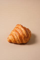 Freshly baked french croissant with beige background