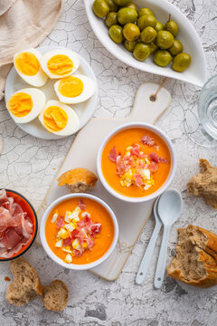 Salmorejo - raw tomato soup with ingredients on a kitchen table,  spanish cuisine for hot summer