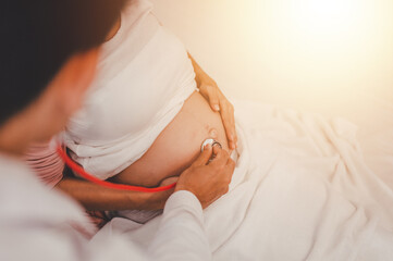Concept Motherhood and Pregnant, Prenatal care and pregnancy, The doctor examined the symptoms of pregnant women and her child for care and safety checks in the womb.