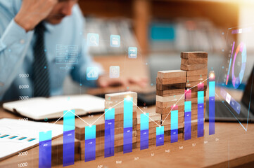 Business and stock trading, financial investment, Plan and strategy concept. Businessmen calculating investments playing stocks and put or placing wood block on the tower in workplace.