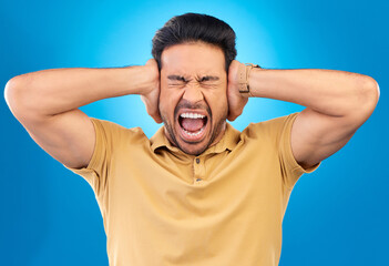 Man covering his ears while screaming in a studio for angry, upset or mad argument expression....