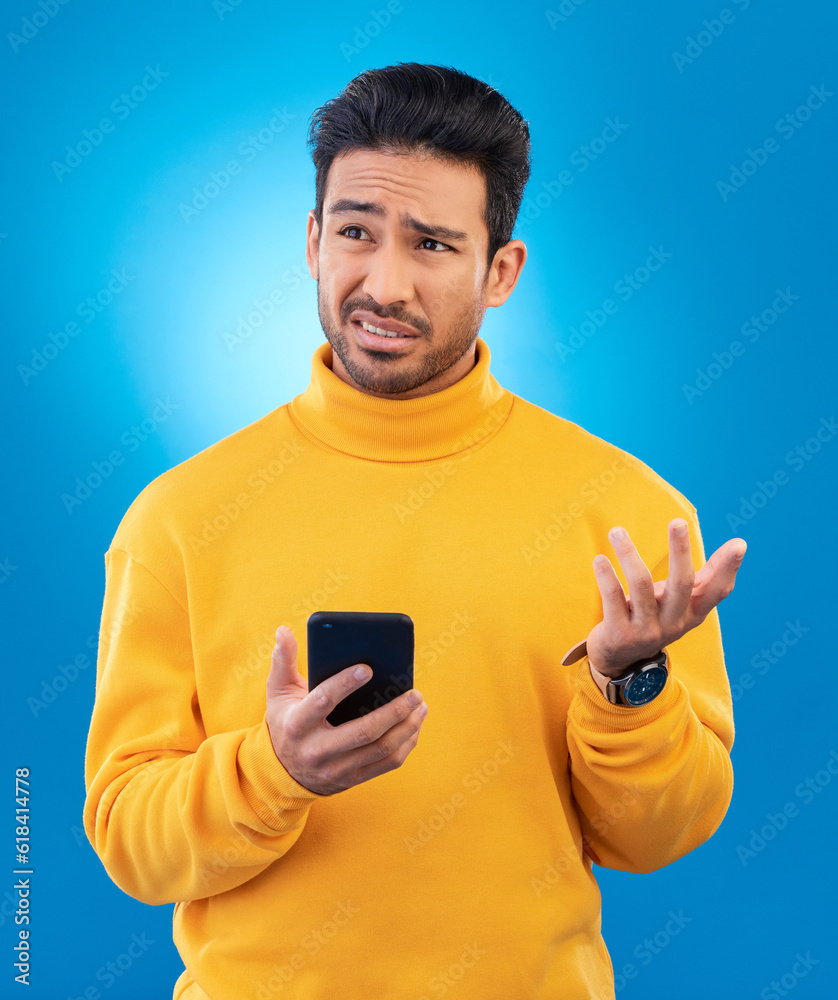 Poster scam, error and asian man with a smartphone, confused and internet issue against a blue studio backg