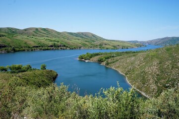 Blue river against the background of green hills