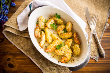 potatoes baked with sesame seeds, herbs and spices in the oven