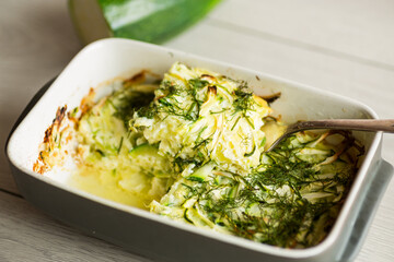 Green zucchini baked in an omelette in the oven, in a ceramic form .