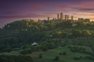 The medieval towers of the village of San Gimignano at sunset. Tuscany, Italy - obrazy, fototapety, plakaty