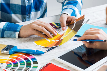 Interior designer choosing colors from swatches