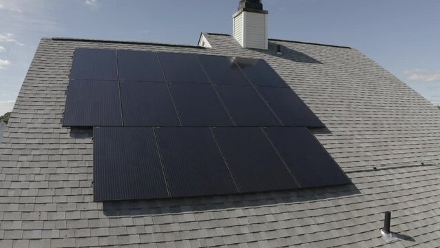 Aerial of the solar panels on the rooftop of a house on a sunny day