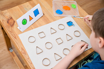 Child learn geometric shapes. Fine motor skills. Preschool or special needs tasks. Early education of children. Montessori methodology.