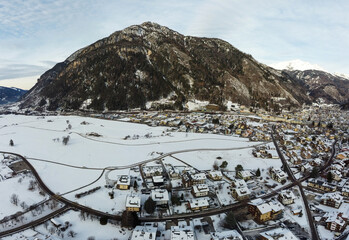 Aerial View of the City of Predazzo,ì covered by the Snow in December, in the North of Italy