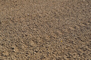 High resolution image of a large, recently plowed field, set on a sunny farm land