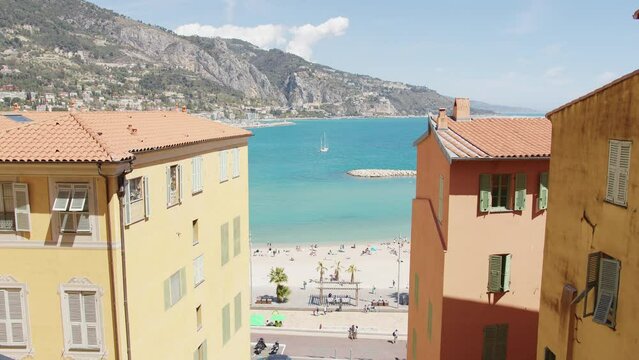Drone shot over traditional houses by Promenade des Anglais beach in Nice, France