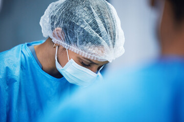 Hospital, surgery and team of doctors in theatre for medical support, teamwork or healthcare solution in face mask. Focus of nurses and surgeon in blue scrubs in operating room, emergency and helping