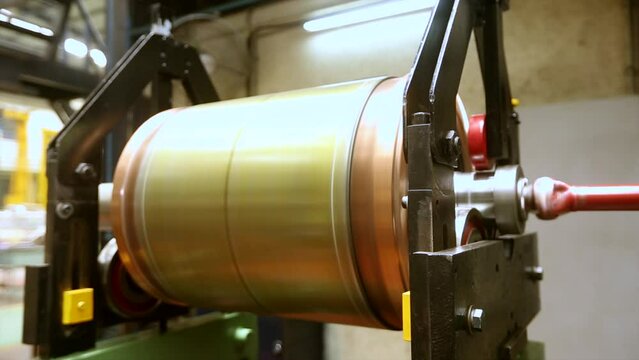 Huge electric motor spinning at the production shop of the factory.