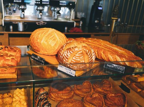 bakery display with various types of breads in glass case