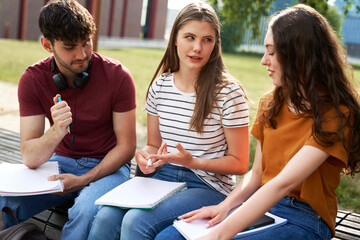 Group of caucasian students studying outside the university campus