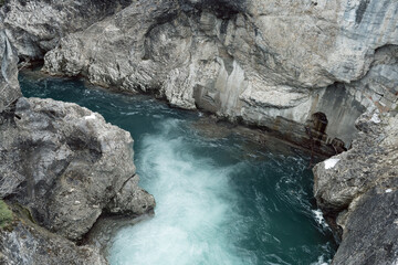 water that flows through the lech fall and is on its way towards the valley. Photographed from a bridge that leads over the Lech. Recorded in winter.