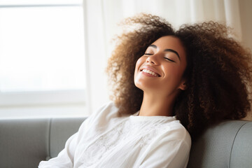 Fototapeta na wymiar Happy afro american woman relaxing on the sofa at home. Generative AI