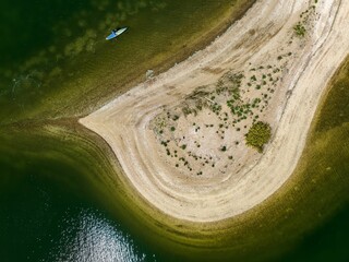 Aerial view over a large sandbar in the green waters of Oyster Bay in Lloyd Harbor on Long Island