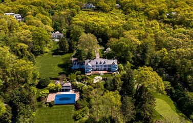 Aerial view over a large house on Long Island, New York on a sunny morning