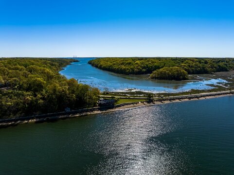 Aerial view over the calm waters in Oyster Bay near Lloyd Harbor, New York on a sunny day - Powered by Adobe