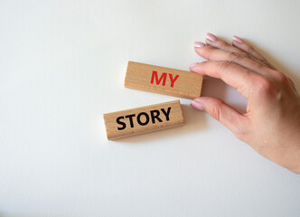 My story symbol. Wooden blocks with words My story Beautiful white background. Businessman hand. Business and My story concept. Copy space.