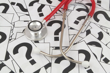 Medical FAQ concept. Stethoscope on many question marks. - obrazy, fototapety, plakaty