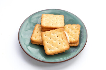Biscuits in plate on white background.