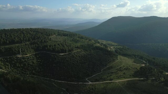 Beautiful aerial view of green range of Mountain Gilboa over a zigzag road in Israel